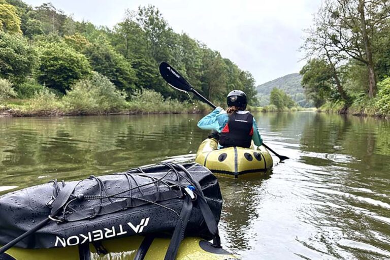 Packraft: 6 essential questions answered 4 A rafter with a backpack navigates a wild river in Luxembourg.