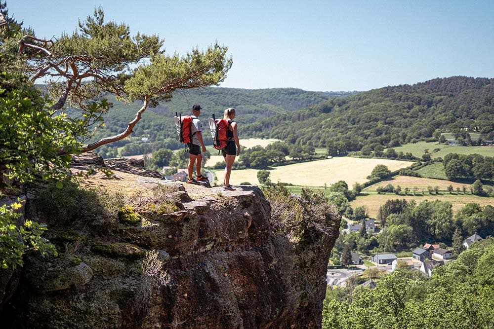 Everything you want to know about packrafting in the Eifel Germany Ardennes 1 a couple of people standing on a cliff overlooking a valley Eifel Germany Ardennes