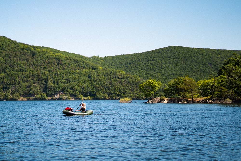 Everything you want to know about packrafting in the Eifel Germany Ardennes 2 a person in a boat on a lake Packrafting Eifel Germany Ardennes