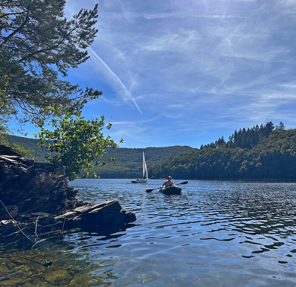 Paddling a packraft on the Rursee lake in the Eifel Germany