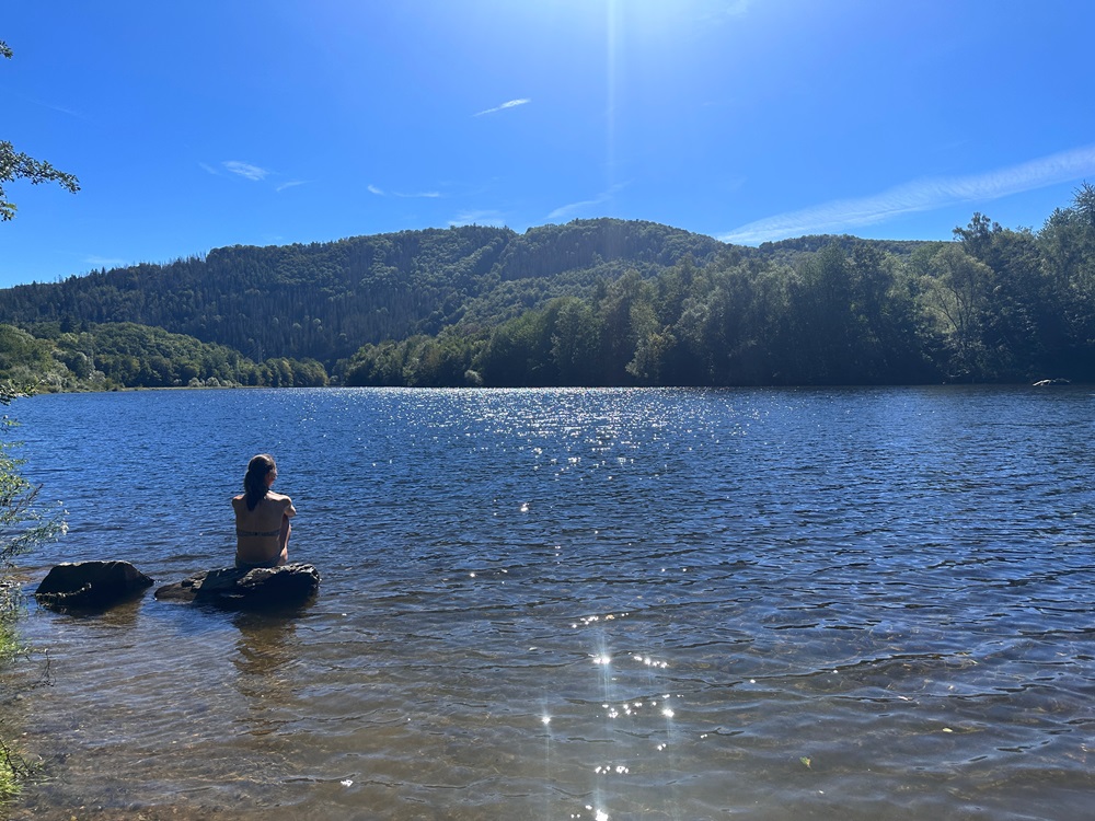 Relaxing at the lake during a packrafting adventure in the Eifel Germany